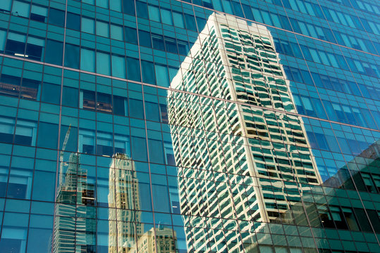 USA, New York, New York City, Skyscraper reflecting in glass wall of building standing opposite