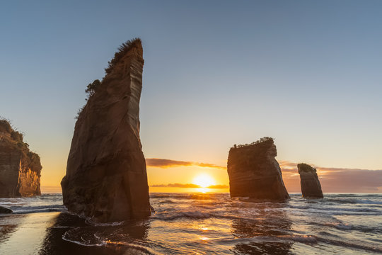 New Zealand, New Plymouth District, Tongaporutu, Three Sisters rock formation at sunset