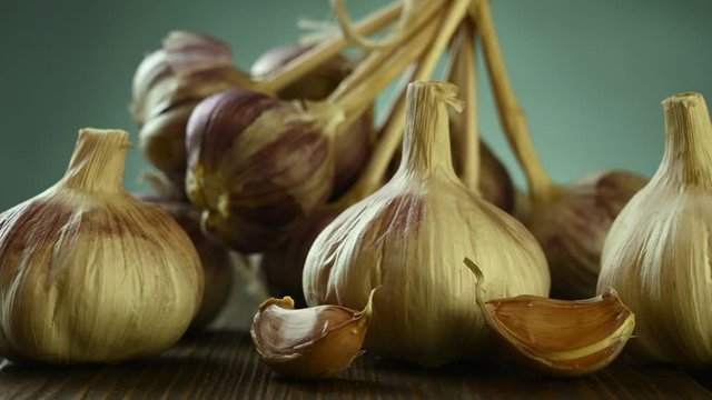 heads of garlic lie on a wooden table