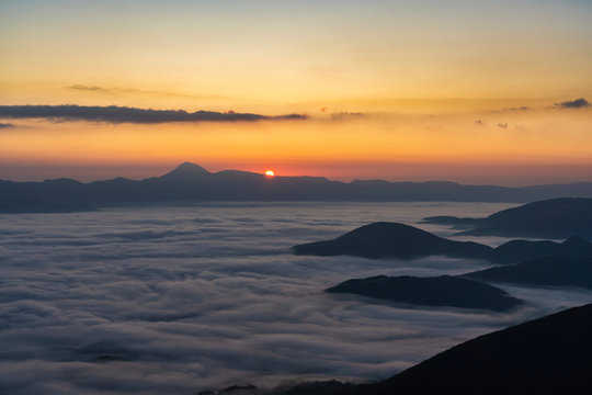 Italy, Thick fog shrouding Monte San Vicino at autumn sunrise