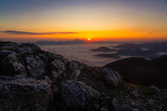 Italy, Thick fog shrouding Monte San Vicino at autumn sunrise