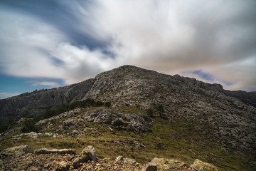 Fototapeta na wymiar Rocky peak with flat mountain vegetation