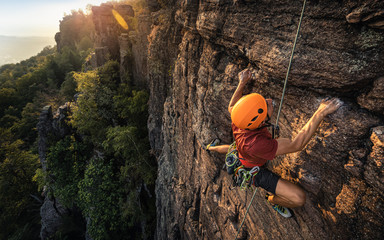 Man climbing Battert rock during sunset