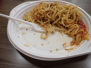  chinese noodles fire with vegetables on a plastic plate