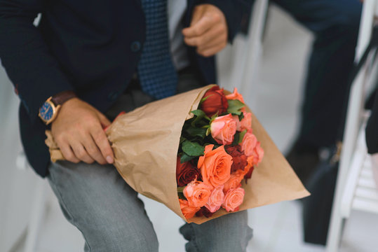 man with red rose bouquet