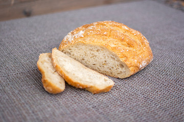 Fresh homemade white bread on the rustic table cloth