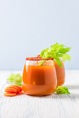 Vegan carrot celery juice in glasses. Copy space.