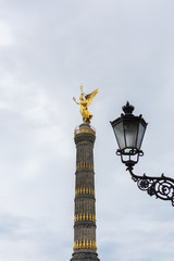 Fototapeta na wymiar Walk through the Tiergarten park in Berlin, the Victory Column and beautiful street lamps, Germany