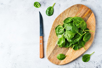 Raw fresh spinach leaves on a stone background