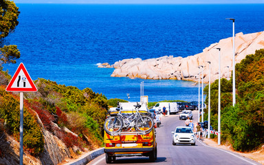 Camper with bicycles on road at Capo Testa in Santa Teresa Gallura at Mediterranean Sea in Sardinia...