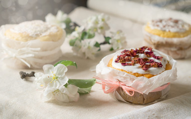 Fototapeta na wymiar Traditional Easter cakes and flowering branches of apple trees