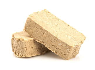 Sunflower halva isolated on white background. Sweet halva dessert slices.