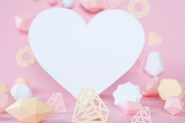 polygonal diamonds made of paper on a pink background