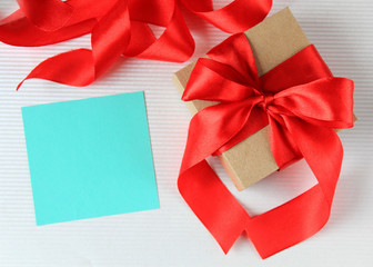 Wrapped vintage gift box with red ribbon bow with