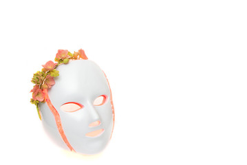 Color therapy mask glowing red with flower crown