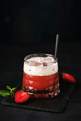 Strawberry smoothie with cream and ice.