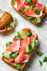 Italian sandwiches with bacon, cucumber and fresh herbs. Ciabatta with meat