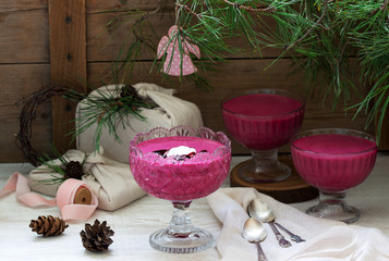 Blackcurrant, orange and cream mousse in a glass bowl. Rustic style.