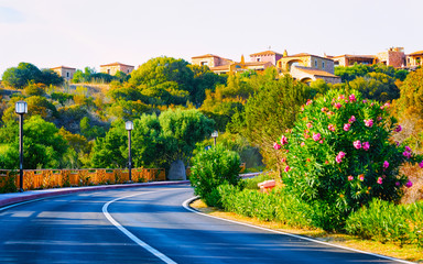 Empty road without cars in Porto Cervo at in Sardinia Island in Italy summer. Driving on the...