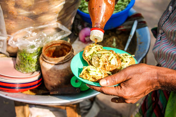 Asian bangladeshi Indian street food velpuri or in india name pani puri. it is very spicy colorful. take the photo in daylight. close shot of a plate of panipuri © MOHAMMADNAZMULHASA