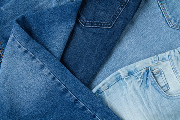 Flat lay of classic blue jeans. Urban outfit, basic essencial wardrobe, shopping concept. Top view. Abstract background