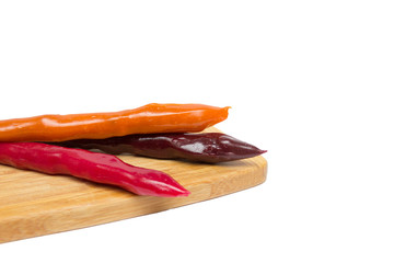Churchkhela on a wooden board isolated on white background, ancient Georgian national sweetness