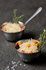 Festive french julienne with sea buckthorn in a bowl on black stone background. Rustic style. Close up, selective focus.