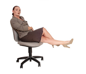 Business woman sitting relaxing on her chair, legs up