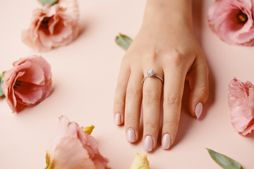 Ring on woman finger.