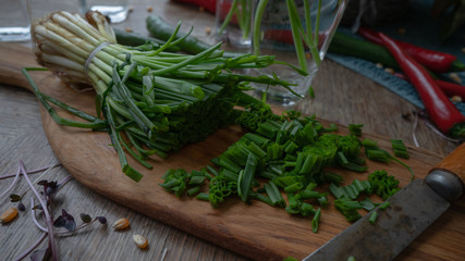Chives and dill on a wooden cutting board. Still life