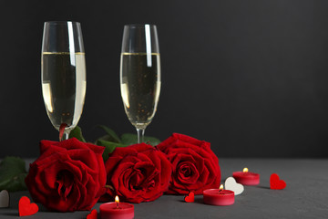 Champagne, flowers and gifts on the table. Valentine's day background.