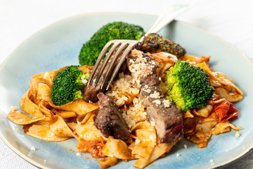tagliatelli with steak slices on a plate