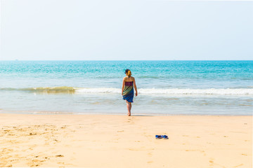 Beautiful beach view with fishing boat, yellow sand and blue ocean, Goa state in India
