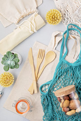 Zero waste concept. Set of eco friendly bamboo cutlery, mesh cotton bag, reusable coffee tumbler. Sustainable, ethical shopping, plastic free lifestyle. top view, flat lay.