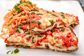 Veal Parmigiana with spaghettiin tomato sauce