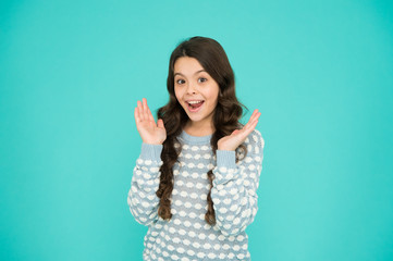 Smiling small girl with long hair. Beauty and health. It s her happy time. Childhood concept. International childrens day. Child care. Happy childhood. Emotional girl. Little girl blue background