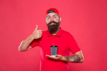 Fototapeta na wymiar bearded man thumb up gesture. brutal hipster uniform. happy barista fresh coffee. try takeaway coffee. best quality of cafe waiter. good morning coffee to go. energy concept. Enjoying morning drink