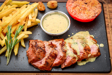 Juicy steak medium rare beef with spices and grilled vegetables