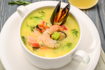 Seafood soup, on a wooden table, with shrimp