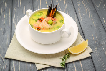 Seafood soup, on a wooden table, with shrimp