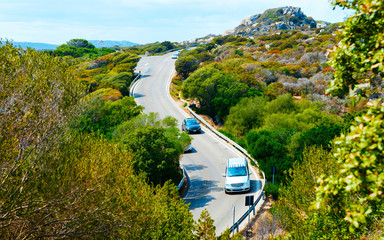 Cars on road at Capo Testa in Santa Teresa Gallura in Sardinia Island in Italy summer. Transport...