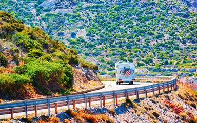 Camper with bicycle on road at Buggerru in Carbonia-Iglesias in Sardinia Island, Italy summer....