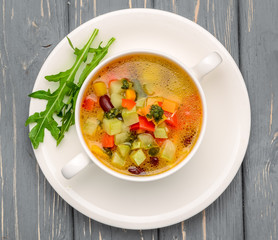 chicken soup with vegetables. On a wooden table