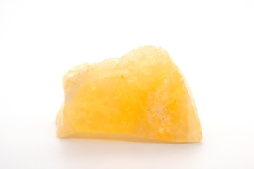 macro shooting of natural mineral rock specimen - raw tea Calcite stone on white marble from Mexico