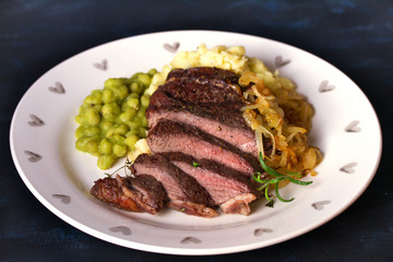 Grilled fillet beef steak with mashed potato, peas and fried onion