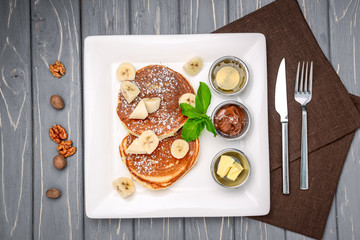 Stack of Turkish -style pancakes with a banana and chocolate