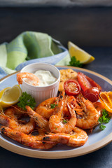 Shrimps or prawns with vegetables, garlic and sauce on plate