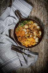 Stewed pork chop in a bright mushroom sauce.