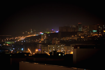 Fototapeta na wymiar Night city skyline. Top aerial panoramic view of modern city fro