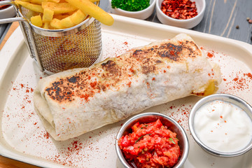 greek gyro wrap cut in half and served with fries